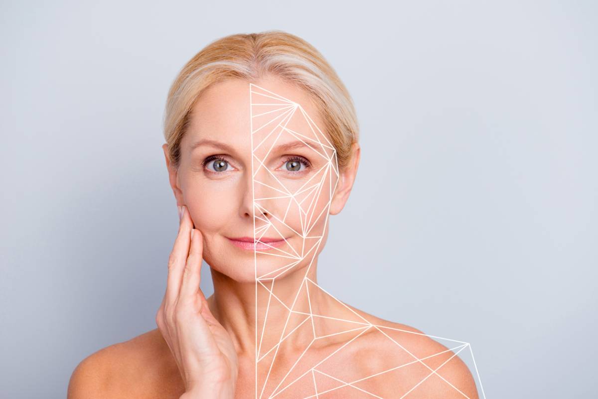 Older woman touching jaw with hand, left side of face and body framed by lines representing structure