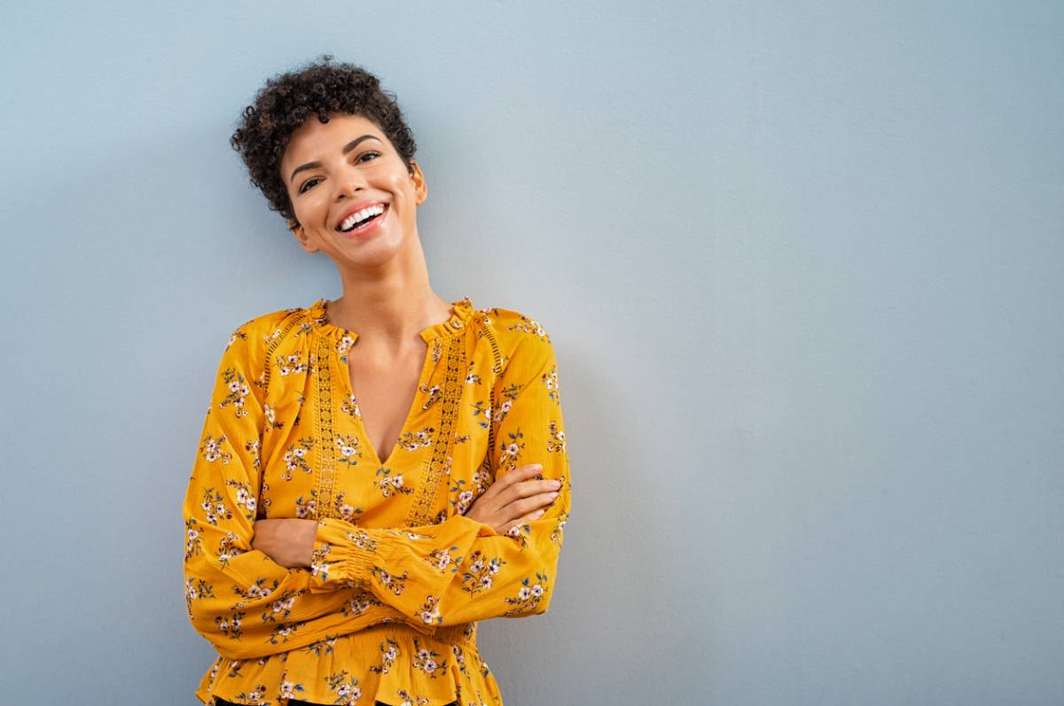 Smiling woman in yellow top